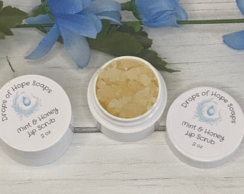 This Lip Sugar Scrub will gently exfoliate dry flaky lips and deeply hydrate them. With all-natural organic butter and oils full of Vitamins E & D and antioxidants, it will also leave your lips feeling completely nourished and replenished. The flavor of mint and vanilla pair beautifully with a touch of honey for a delicious taste. Our lip scrub is perfect for anyone looking for a quick and easy way to get soft and kissable lips. 