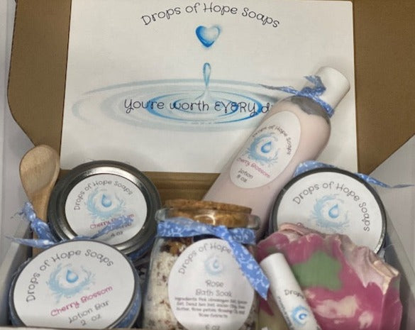 All-Natural Deluxe Skin Care Set.  Cherry Blossom fragrance.  Set includes bath salts, lip balm, lotion, lotion bar, body butter, and sugar scrub.  All-Natural organic ingredients.
