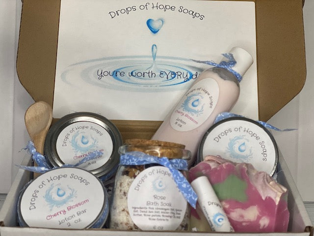 All-Natural Deluxe Skin Care Set.  Cherry Blossom fragrance.  Set includes bath salts, lip balm, lotion, lotion bar, body butter, and sugar scrub.  All-Natural organic ingredients.