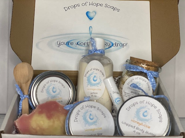 All-Natural Deluxe Skin Care Set. Honeysuckle fragrance. Set includes bath salts, lip balm, lotion, lotion bar, body butter, and sugar scrub. All-Natural organic ingredients.