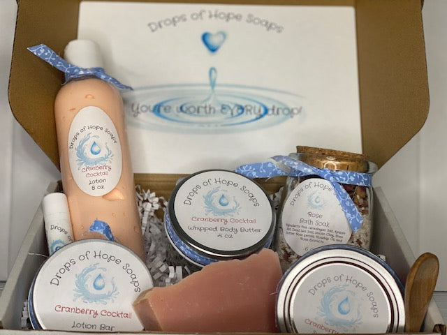 All-Natural Deluxe Skin Care Set.  Cranberry Cocktail fragrance.  Set includes bath salts, lip balm, lotion, lotion bar, body butter, and sugar scrub.  All-Natural organic ingredients.